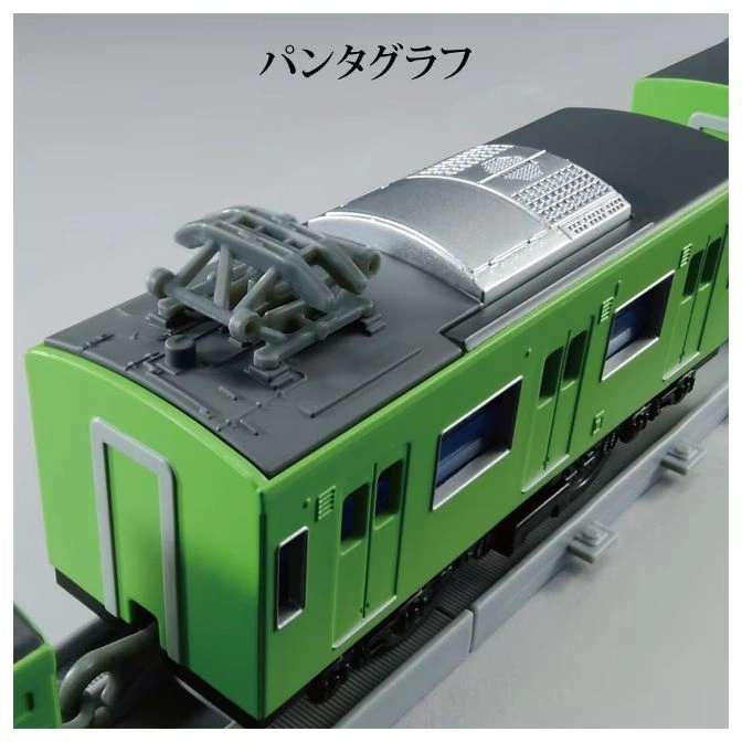  Green toy train with pantograph on a gray track.