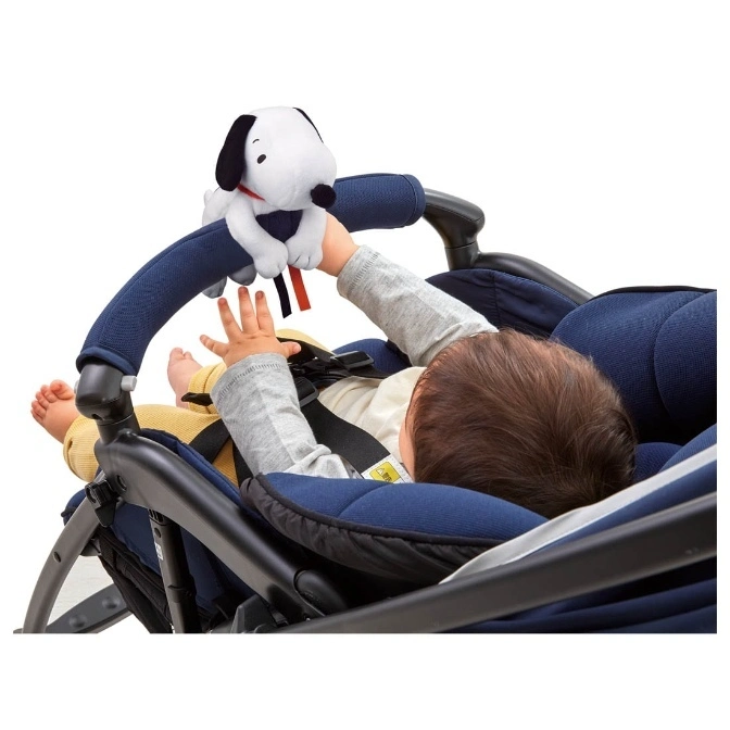  Baby in stroller reaches for Snoopy plush toy attached to the stroller bar.