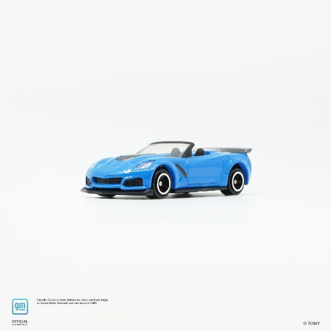  Blue toy Corvette convertible with black accents and detailed wheels on a white surface.