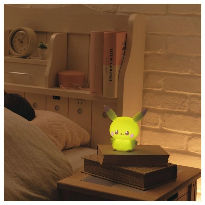  Glowing Pikachu nightlight on a bedside table, casting a warm light.