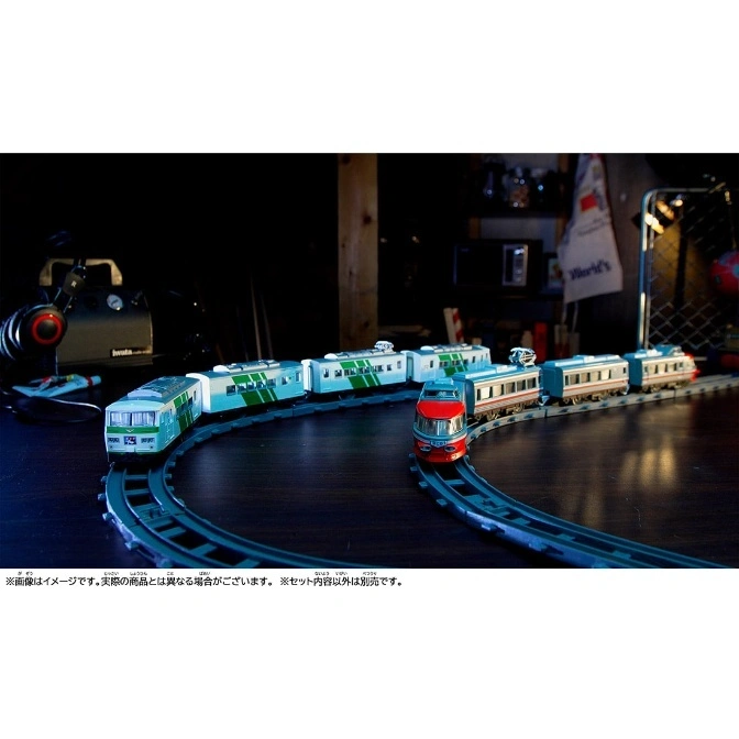  Toy train set with green and red trains on a blue track.