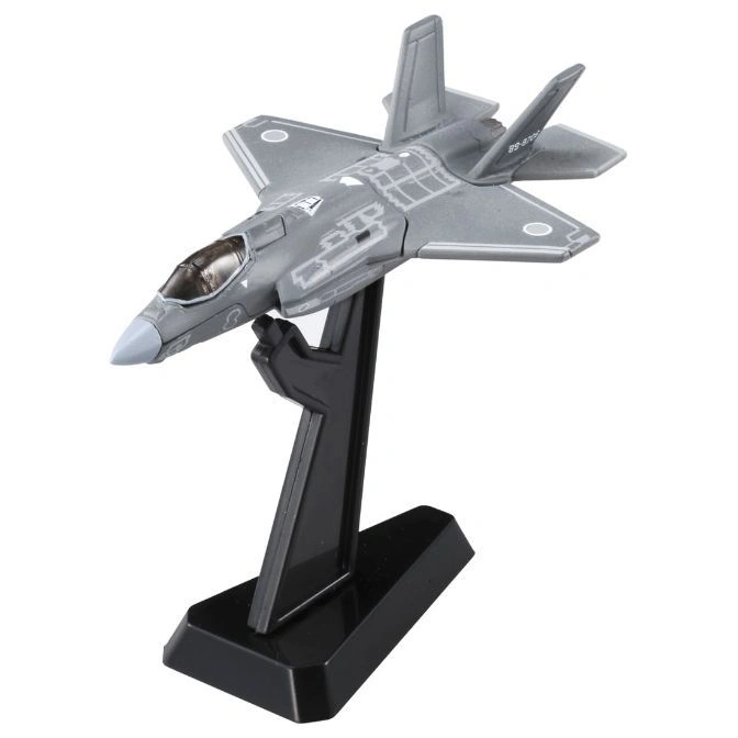Gray F-35 fighter jet model on a black stand, showcasing its stealth design and markings.