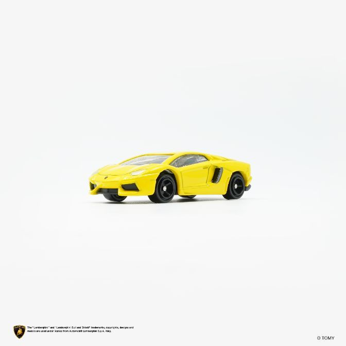  Yellow toy Lamborghini Aventador with black wheels on a white background.