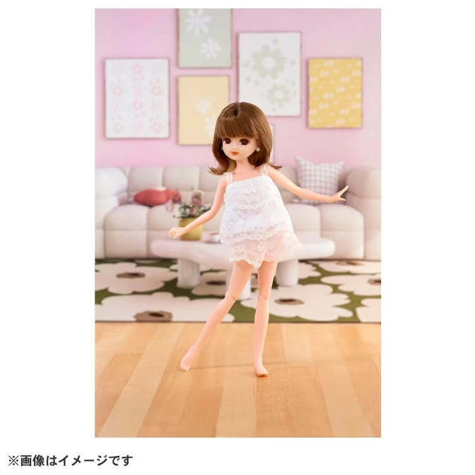  Licca-chan doll in a white lace dress, standing in a dollhouse living room.