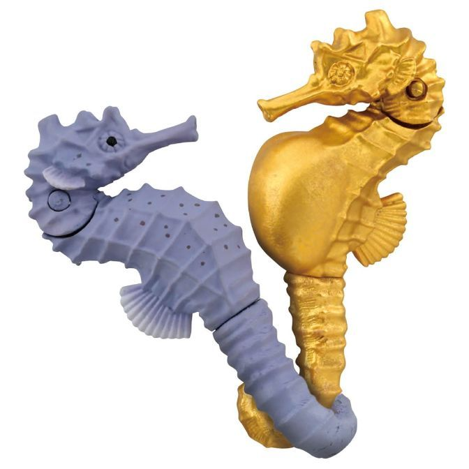  Two seahorse toys, one gold and one lavender, stand side-by-side.