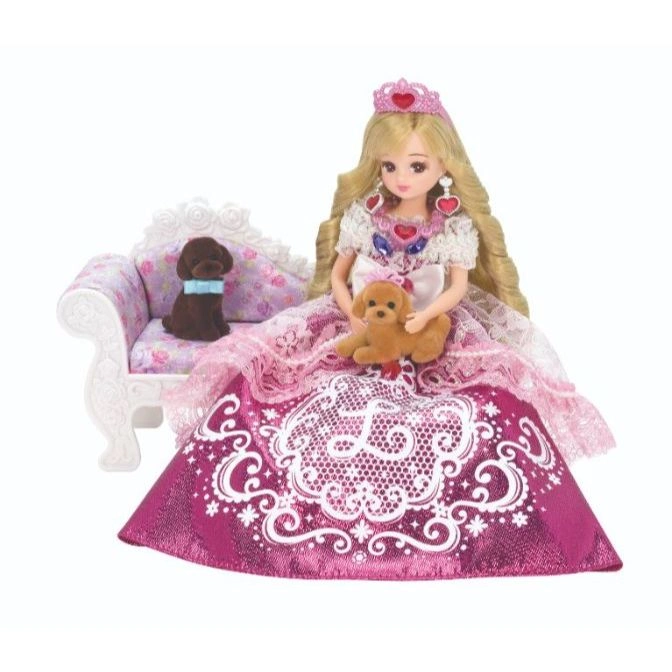  Doll princess with blonde hair, crown, pink dress, holding a toy poodle, with a toy dog on a couch.