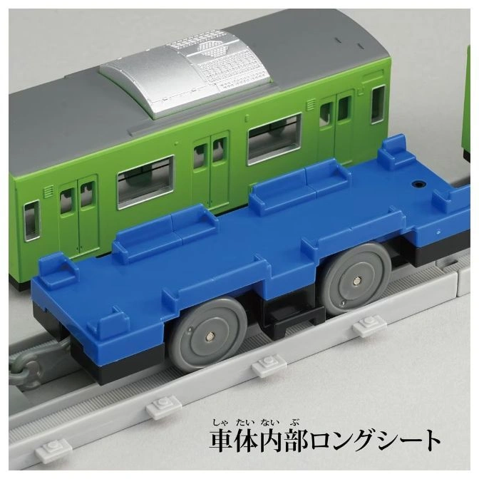  Toy train with green passenger car and blue flatcar on gray tracks.