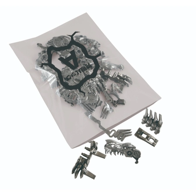  Silver robot dinosaur toy parts in and around a plastic bag, ready for assembly.