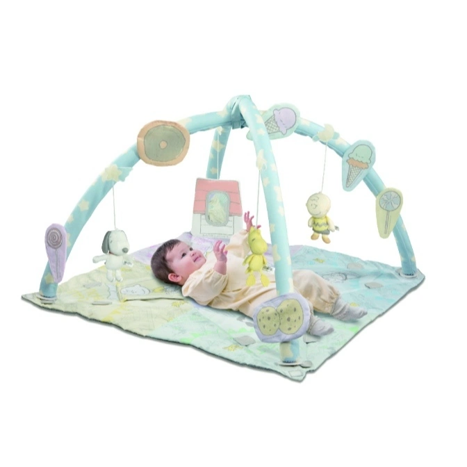 Baby lying under a Snoopy-themed activity gym with hanging toys.