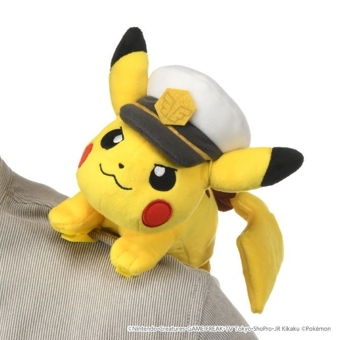 Pikachu plush wearing a captain's hat perched on a person's shoulder.