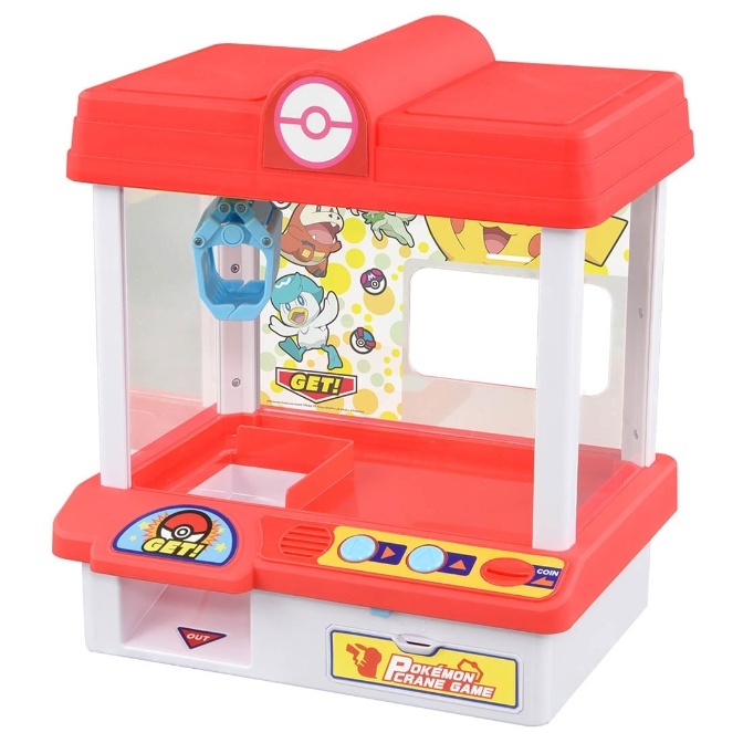 Pokémon crane game toy with red and white design, featuring a claw and Pokémon character graphics.