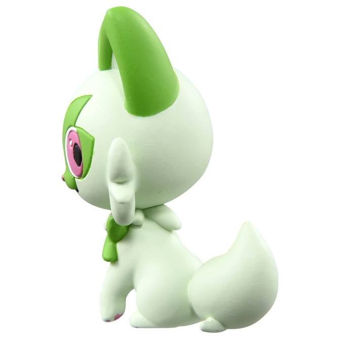 White and green Pokémon toy figure with pink eyes and a curled tail.