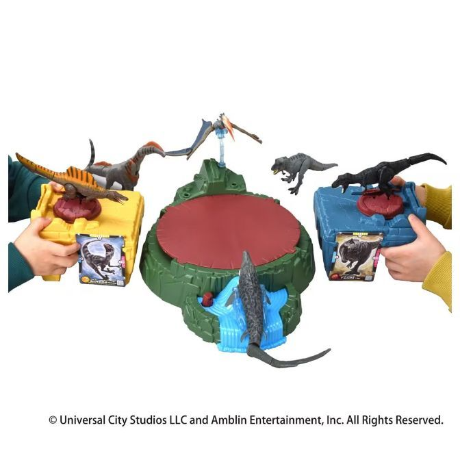  Dinosaur toy set with arena, figures, and interactive cards held by hands.