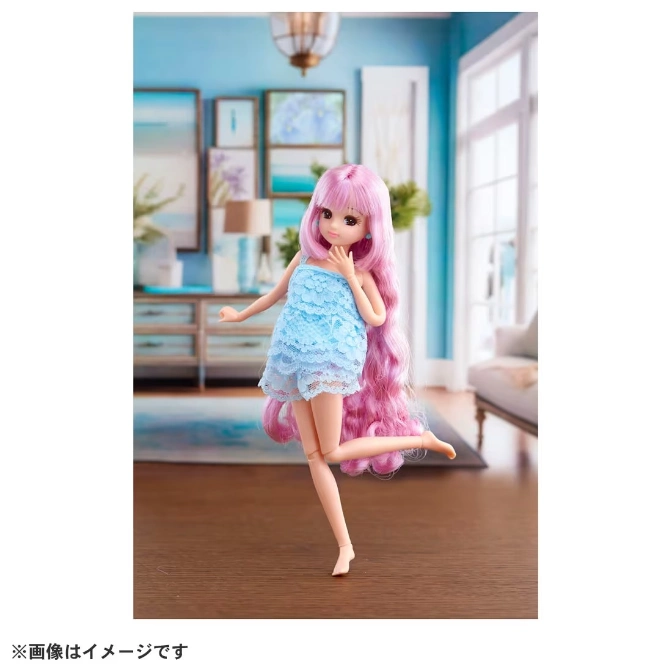  Doll with pink hair in a blue lace dress striking a pose in a living room setting.