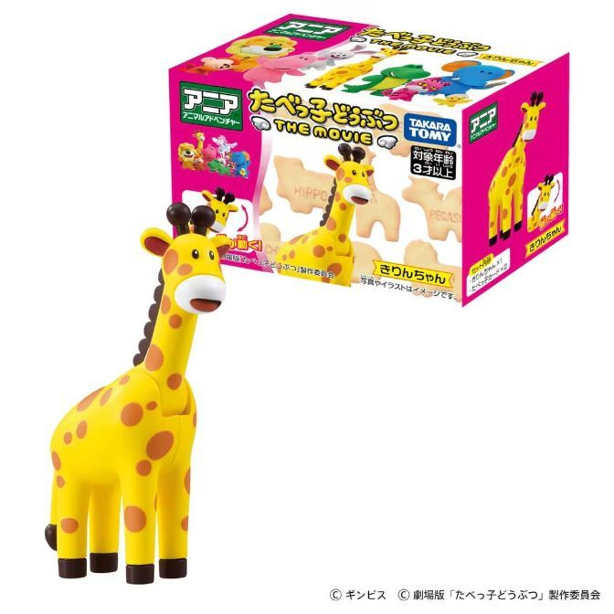  Yellow giraffe toy with brown spots, next to its box featuring animal crackers.